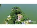 Aerial view of waterfront property with lush trees and private dock at 160 Quail Hollow Dr, Kings Mountain, NC 28086