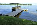 Lakeside property features a private dock with a pontoon boat ready for summer fun at 160 Quail Hollow Dr, Kings Mountain, NC 28086
