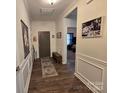 Warm hallway with hardwood floors, neutral walls, and decorative molding at 16115 Commodore Dr, Lancaster, SC 29720