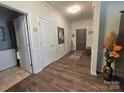 Open hallway featuring wood floors, white trim, and access to other rooms at 16115 Commodore Dr, Lancaster, SC 29720