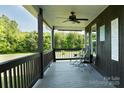 Relaxing covered porch area with wooden floors and decorative wall art, perfect for enjoying outdoor views at 1640 Bear Poplar Rd, Cleveland, NC 27013