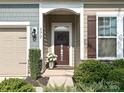 Inviting front entrance with decorative door decor and manicured landscaping at 177 Yellow Birch Loop, Mooresville, NC 28117