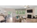 Comfortable living room with a fireplace, large windows, and hardwood floors at 2009 Trindle Vine Ln, Waxhaw, NC 28173