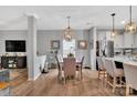 Elegant dining area with stylish light fixture and view into kitchen and living area at 210 Clove Hitch Dr, Salisbury, NC 28677