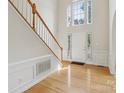 Bright foyer with hardwood floors, staircase and natural light streaming through the windows at 2321 Oberwood Dr, Charlotte, NC 28270