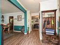 Bright foyer featuring a coat rack, vibrant accent wall, wood floors, and views into the living spaces at 2848 Huckleberry Hill Dr, Fort Mill, SC 29715