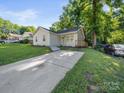 Well-maintained home with a long driveway and a green lawn at 3133 Amay James Ave, Charlotte, NC 28208