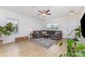 Bright living room featuring hardwood floors, a comfortable sectional sofa, and large windows at 3304 Saddlebrook Dr, Midland, NC 28107