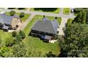 An aerial view of the house's backyard reveals a well-manicured lawn, mature trees, and a covered patio at 3963 Harmattan Dr, Denver, NC 28037