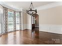 Elegant dining room with dark hardwood floors, stylish chandelier, and bright bay windows at 4218 Ash Hollow Ln, Denver, NC 28037