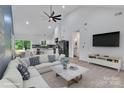 Bright open-concept living room with vaulted ceilings and modern black appliances at 516 North Mulberry St, Cherryville, NC 28021