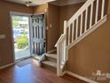 Entryway featuring wood floors, staircase, and a view through the glass front door at 5650 Kimmerly Woods Dr, Charlotte, NC 28215