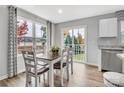 Sunlit dining area with wood floors, stylish decor, and views of the landscaped backyard at 5995 Granbury Dr, Kannapolis, NC 28081
