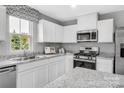 Modern kitchen with white cabinets, stainless steel appliances, and granite countertops at 5995 Granbury Dr, Kannapolis, NC 28081