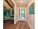 Entryway with hardwood floors, artwork, and a view into the living area and large windows at 617 Pinecrest St, Davidson, NC 28036
