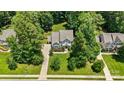 A picturesque aerial view of a beautifully landscaped home with a long driveway at 6422 Northern Red Oak Dr, Mint Hill, NC 28227