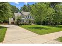 View of the two-car garage and manicured lawn with sidewalk leading to the front door at 6422 Northern Red Oak Dr, Mint Hill, NC 28227