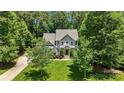 An elevated view of the traditional home surrounded by mature trees and landscaping at 6422 Northern Red Oak Dr, Mint Hill, NC 28227