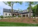 Striking home with dormers, a 3-car garage, and a manicured front yard creating exceptional curb appeal at 8170 Bay Pointe Dr, Denver, NC 28037