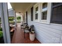 Inviting front porch with a decorative tile floor, comfortable seating, and views of the landscaped front yard at 899 Wendover Rd # 29, Statesville, NC 28677