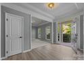 Bright foyer with light wood floors leading to the living room and front door view at 9937 Violet Cannon Nw Dr, Concord, NC 28027