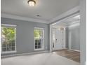 Cozy living room featuring carpeted floors and large windows, providing plenty of natural light at 9937 Violet Cannon Nw Dr, Concord, NC 28027