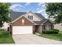 Charming single-Gathering home featuring a well-manicured lawn, brick accents and two-car garage at 10211 Dominion Village Dr, Charlotte, NC 28269