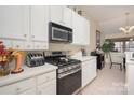 Bright kitchen featuring white cabinets, stainless steel appliances, and eat-in dining space at 10211 Dominion Village Dr, Charlotte, NC 28269