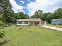 Traditional one story home with a green lawn, lovely landscaping and a long driveway, perfect for parking at 12423 Softwood Ct, Charlotte, NC 28273