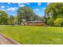 Spacious front lawn with a charming brick home and an additional outbuilding in the back at 1321 Arbor Dr, Salisbury, NC 28144
