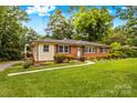 Well-maintained brick home with inviting landscaping and a cozy covered porch for relaxation at 1321 Arbor Dr, Salisbury, NC 28144