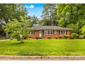 Attractive brick home featuring a well-kept lawn and classic design elements at 1321 Arbor Dr, Salisbury, NC 28144