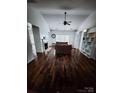 Bright living room boasting hardwood floors, a fireplace, and built-in bookshelves at 13409 Planters Row Dr, Charlotte, NC 28278