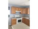 Functional kitchen with wooden cabinets, white appliances, and ample counter space at 136 Mangum Cir, Mooresville, NC 28117