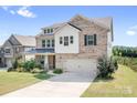 Attractive brick two-story home with a well-kept lawn and attached two-car garage at 16324 Loch Raven Rd, Huntersville, NC 28078