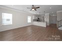 Open-concept living room featuring hardwood floors and a breakfast bar overlooking the modern white kitchen at 2207 Catawba Trace Dr, Catawba, NC 28609