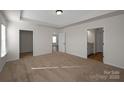 Spacious bedroom with tray ceiling, carpet, and ensuite bathroom with vanity and tile floors at 2207 Catawba Trace Dr, Catawba, NC 28609