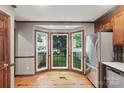 Bright kitchen features a bay window, stainless steel refrigerator, and beautiful hardwood floors at 2308 Blair House Ct, Charlotte, NC 28270