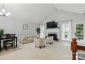 Bright living room boasts a fireplace, vaulted ceilings, neutral palette and seamless access to the outdoor deck at 2308 Blair House Ct, Charlotte, NC 28270