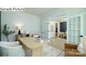 Bright office features French doors, a large desk, and views into the dining and kitchen area at 265 Miramar Dr, York, SC 29745