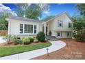 Beautiful home featuring a winding walkway, mature landscaping, and classic architectural details at 4126 Tyndale Ave, Charlotte, NC 28210