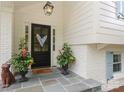 Close up of the entryway showcasing a stylish door, potted plants, and stone porch at 4126 Tyndale Ave, Charlotte, NC 28210