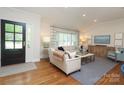 Inviting living room featuring wood floors, bright windows, and comfortable seating area at 4126 Tyndale Ave, Charlotte, NC 28210