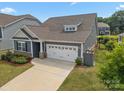Well-maintained home featuring a two-car garage and manicured lawn, situated on a lovely lot at 4427 Poplin Grove Dr, Indian Trail, NC 28079