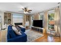 Bright living room with a fireplace, built-in shelving, large windows, hardwood flooring and comfortable seating at 4439 Brandie Glen Rd, Charlotte, NC 28269
