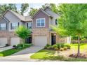 Charming townhome with attached garage, green lawn and mature landscaping at 5033 Mockernut Ln, Indian Land, SC 29707