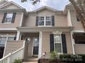 Close-up of a two-story townhome featuring neutral siding, black shutters, and a charming front entrance at 6307 Rhodins Ln, Fort Mill, SC 29707