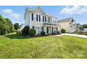 Traditional two-story home with a well-maintained lawn and mature landscaping at 7442 Sparkleberry Dr, Indian Trail, NC 28079