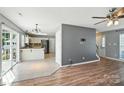 Open-concept living area with hardwood floors, seamlessly connecting to the adjacent kitchen at 7442 Sparkleberry Dr, Indian Trail, NC 28079