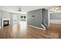 Bright living room featuring a cozy fireplace, hardwood floors, and a view to the outdoor deck at 7442 Sparkleberry Dr, Indian Trail, NC 28079